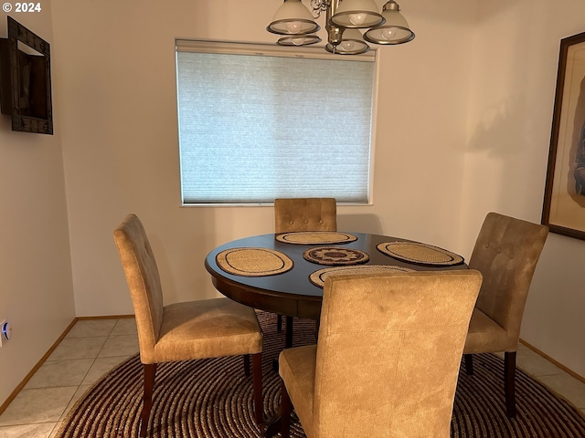 dining room featuring a notable chandelier and light tile patterned flooring