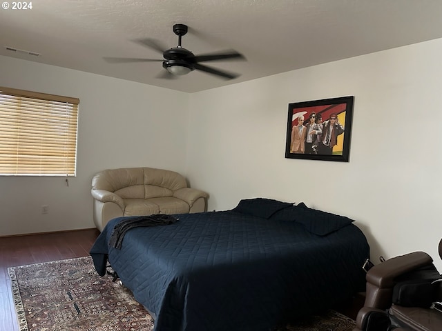 bedroom with ceiling fan and hardwood / wood-style floors