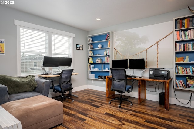 office with dark wood-type flooring and built in features