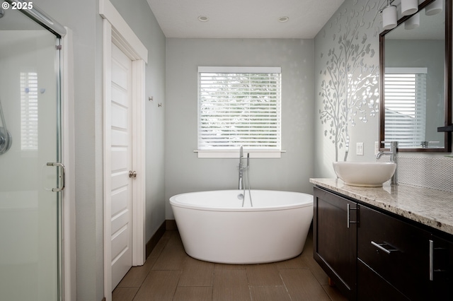 bathroom with vanity and separate shower and tub