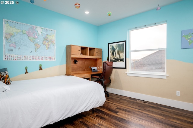 bedroom with dark hardwood / wood-style flooring