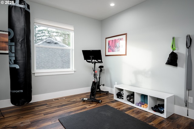 workout area with dark wood-type flooring