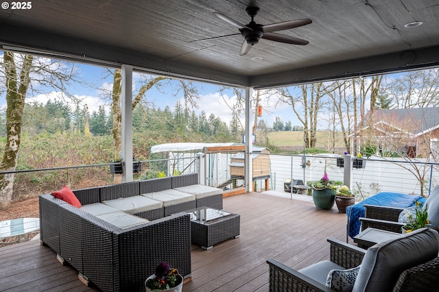 wooden deck featuring outdoor lounge area and ceiling fan