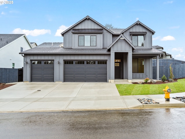 view of front of home with concrete driveway, a shingled roof, board and batten siding, and fence