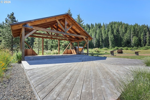 exterior space with a deck, a gazebo, and concrete driveway