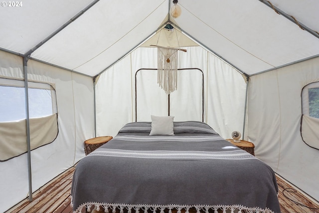 bedroom with lofted ceiling and hardwood / wood-style floors