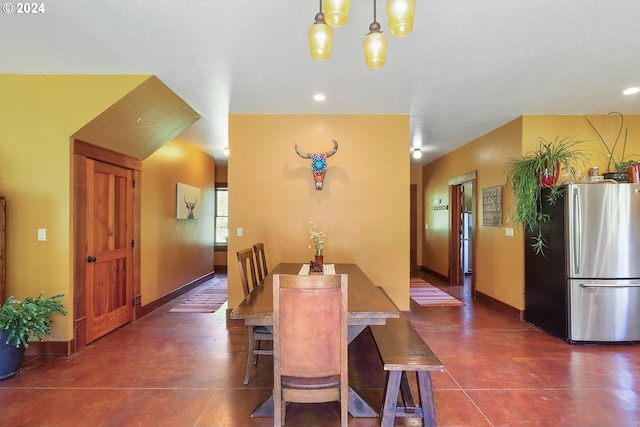 dining room featuring an inviting chandelier and baseboards