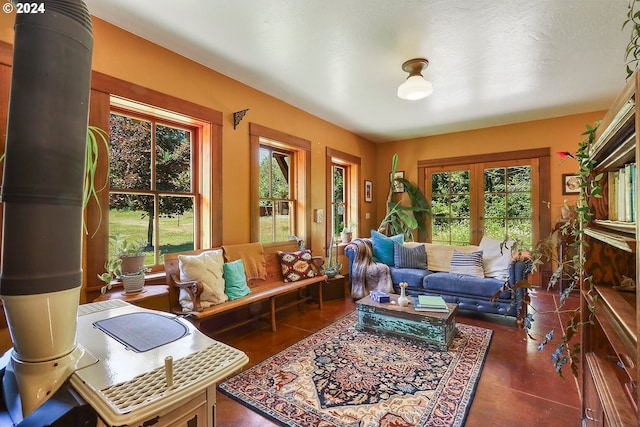 living room with a textured ceiling and a wood stove