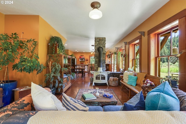 living room featuring a wood stove and dark wood-type flooring