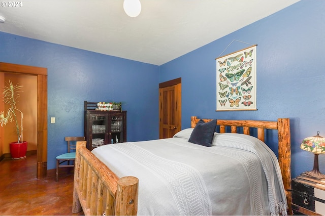 bedroom featuring concrete flooring