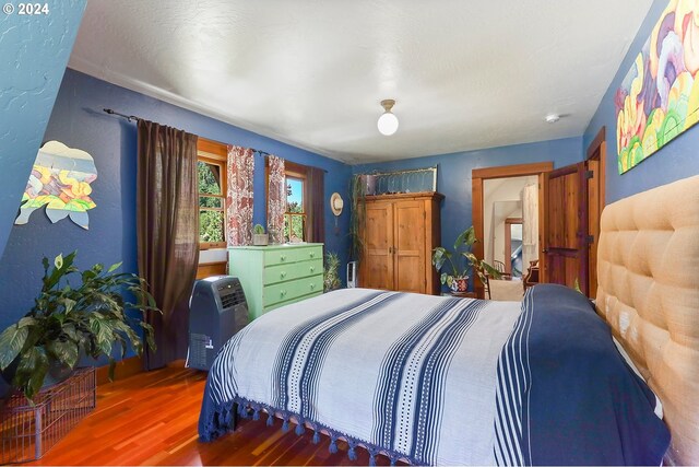 bedroom with wood finished floors