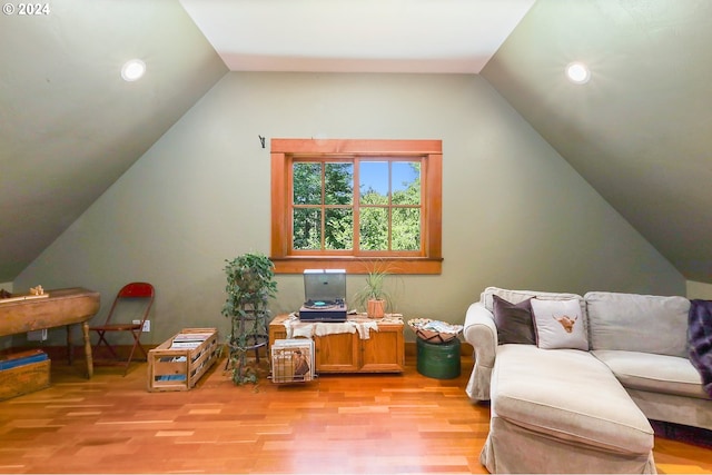 playroom featuring light wood-type flooring and vaulted ceiling