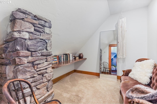 living area featuring lofted ceiling and carpet flooring