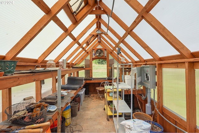 sunroom / solarium featuring vaulted ceiling with beams