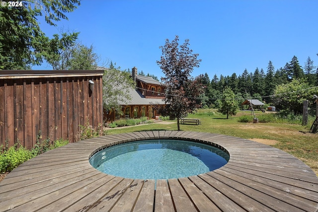 view of pool featuring a lawn and hot tub deck surround