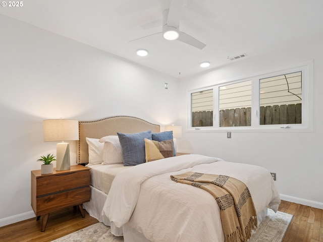 bedroom with ceiling fan and light hardwood / wood-style flooring