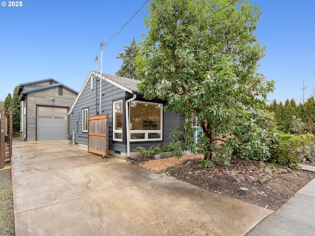 view of front of house with a garage and an outdoor structure