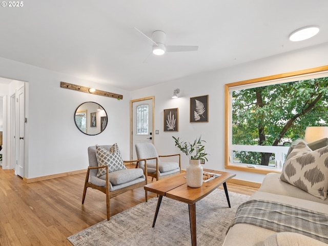 living room with light hardwood / wood-style floors and ceiling fan