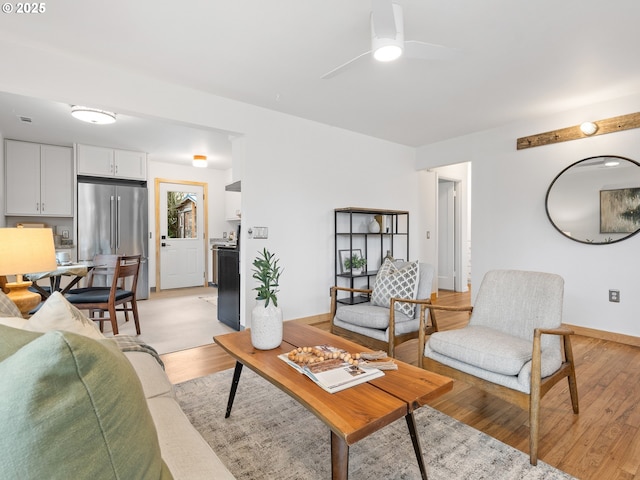 living room with ceiling fan and light wood-type flooring