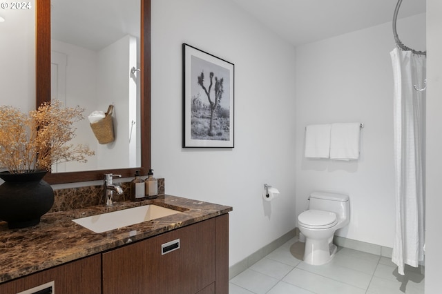 bathroom featuring vanity, toilet, and tile patterned floors