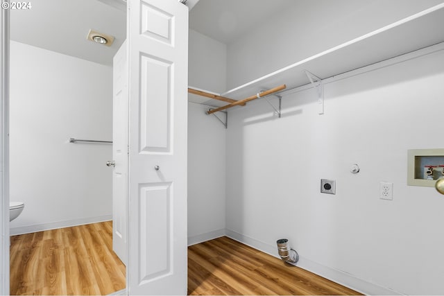 clothes washing area with electric dryer hookup, gas dryer hookup, light wood-type flooring, and hookup for a washing machine