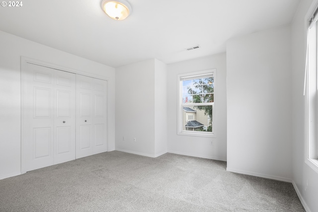 unfurnished bedroom featuring a closet and carpet