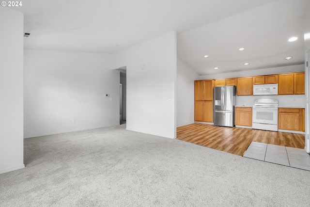 kitchen featuring light hardwood / wood-style flooring and white appliances