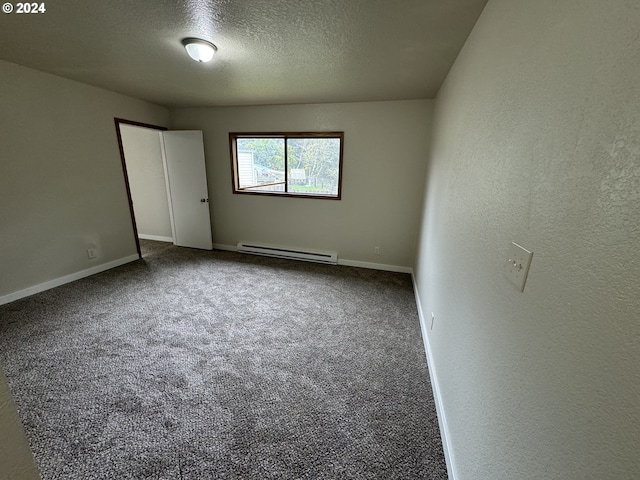 carpeted spare room with a textured ceiling and baseboard heating