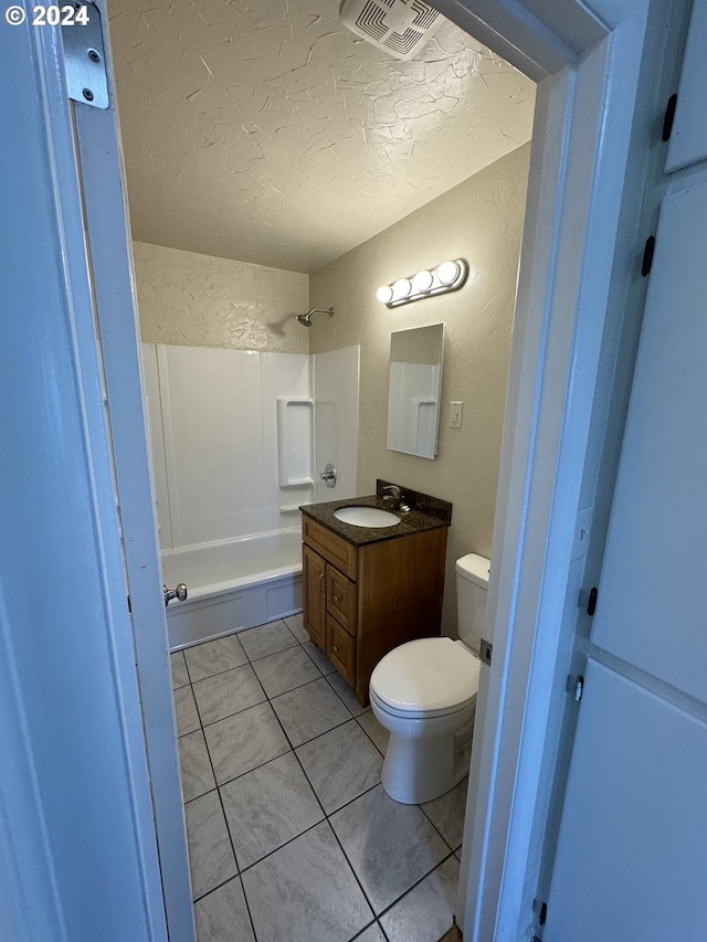 full bathroom with tile patterned floors, vanity, a textured ceiling, shower / bathing tub combination, and toilet