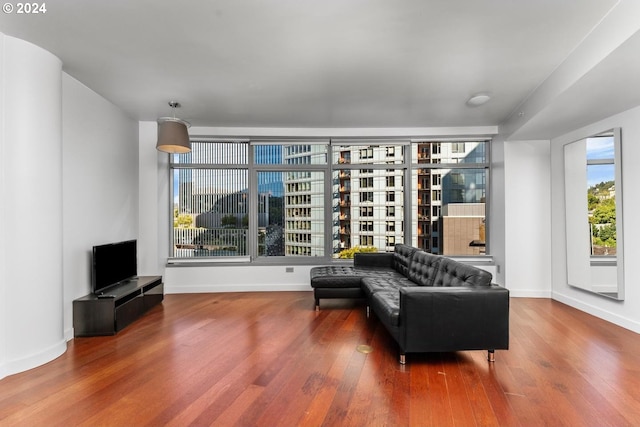 sitting room with baseboards and wood finished floors