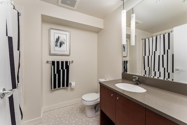 bathroom featuring vanity, toilet, and tile patterned floors