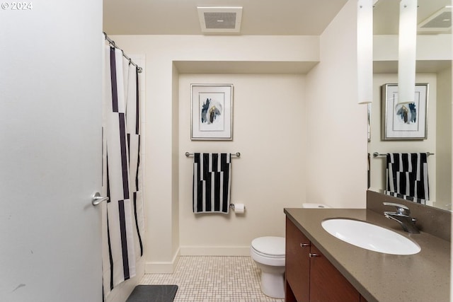 bathroom featuring vanity, toilet, baseboards, and visible vents