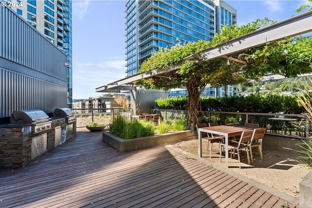 deck featuring grilling area and an outdoor kitchen