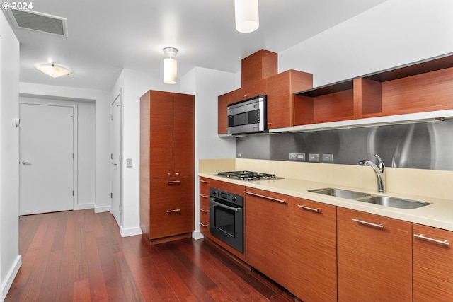 kitchen with visible vents, a sink, open shelves, appliances with stainless steel finishes, and dark wood-style flooring