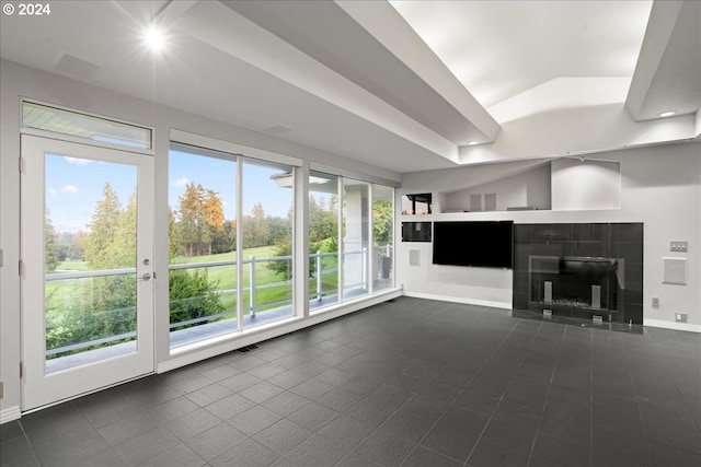 unfurnished living room with a fireplace and a tray ceiling