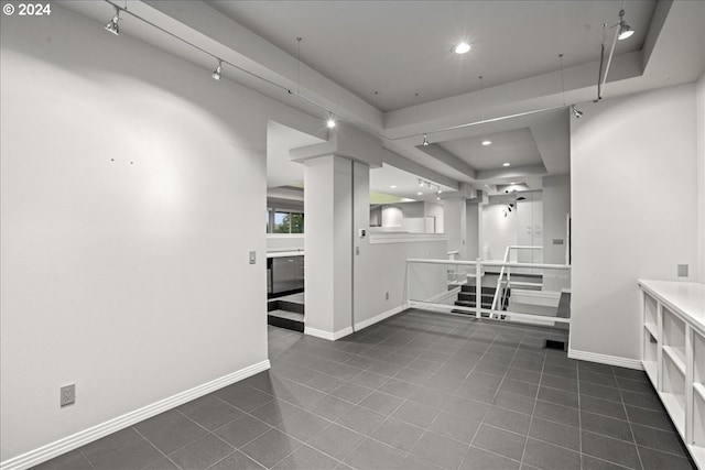 spare room featuring dark tile patterned floors