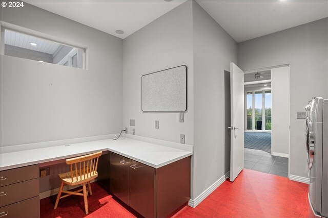 carpeted home office featuring built in desk