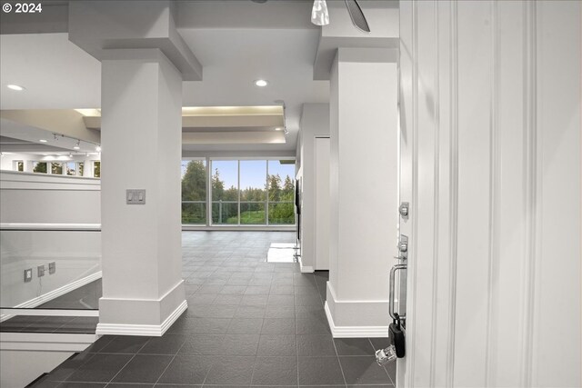 hall with dark tile patterned floors