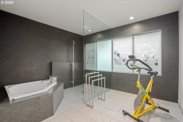 bathroom with tile patterned floors, tile walls, and plus walk in shower