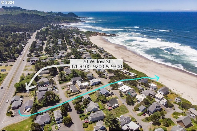 birds eye view of property featuring a water view and a view of the beach