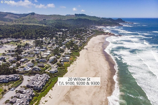 aerial view featuring a water and mountain view and a beach view