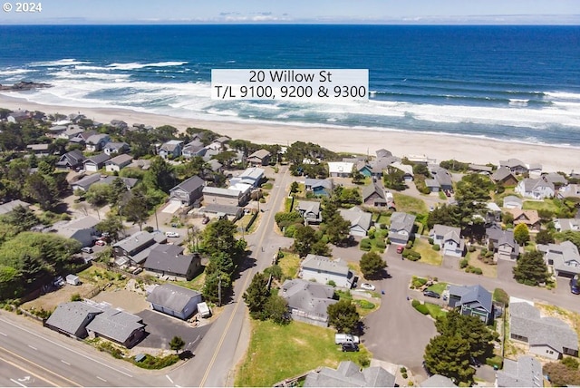 drone / aerial view with a water view and a view of the beach