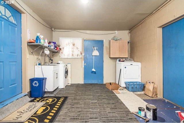 washroom featuring cabinets and separate washer and dryer