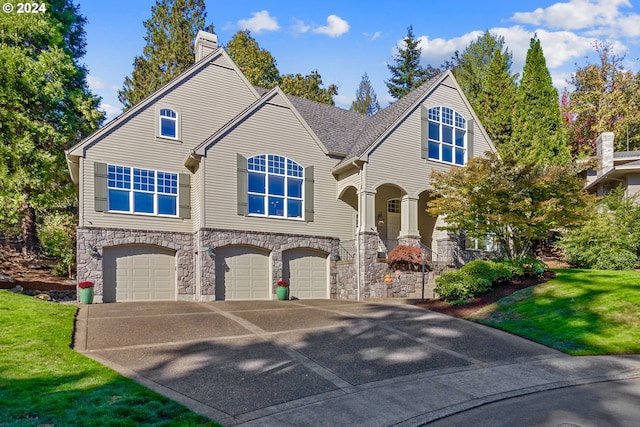 view of front of home with a garage and a front lawn