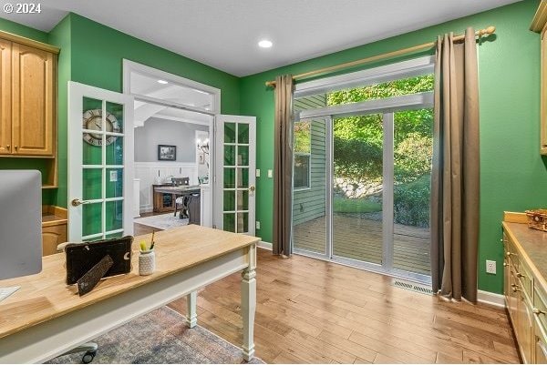 entryway featuring light wood-type flooring and french doors