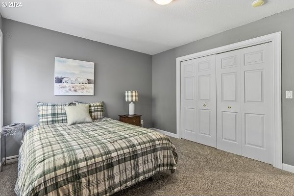 bedroom with a closet and carpet floors