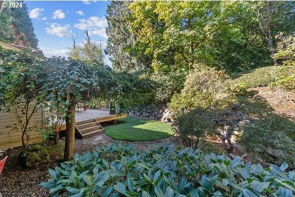 view of home's community with a yard and a wooden deck