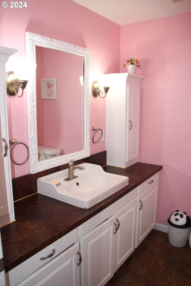 bathroom featuring vanity and toilet