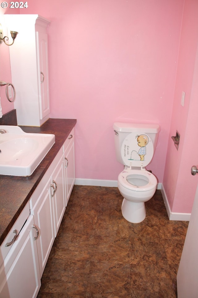 bathroom featuring vanity and toilet