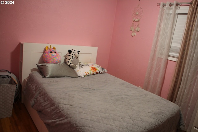 bedroom with wood-type flooring